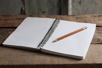 Open notebook, pencil on weathered wood