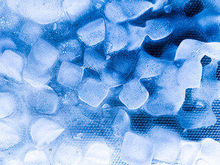 Top view of transparent ice cubes arranged neatly. Background with ice cubes. The background blue...