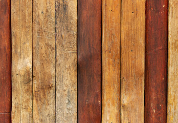 A wooden wall with brown and red stripes