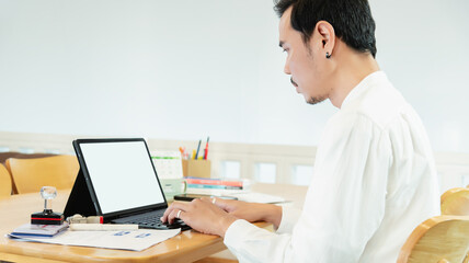 Man typing on laptop at desk, side view for telework, online, man, businessman and laptop screen in home office for articles, business news and data transmission.