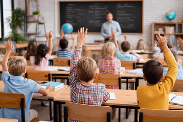 a classroom full of children raising their hands in the air in front of a blackboard with a teacher