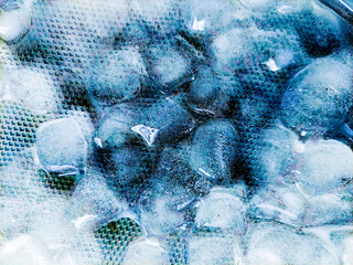 Top view of transparent ice cubes arranged neatly. Background with ice cubes. The background blue...