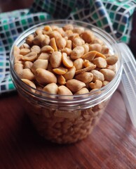 roasted peanuts in an open jar