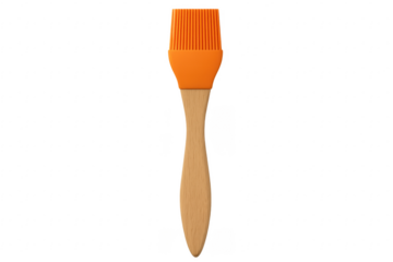 Orange silicone pastry brush with wooden handle on transparent background