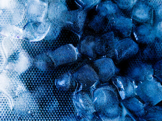 Top view of transparent ice cubes arranged neatly. Background with ice cubes. The background blue...