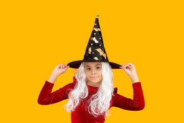 Happy Halloween. Girl witch in Halloween costume isolated on yellow. Trick or treat. Celebrate All...