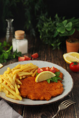 A Viennese schnizel with french fries	