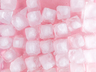 Top view frozen ice cubes on pink background. A set of transparent ice cubes, no shadow, ice cube crystal.