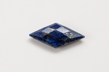 Lapis Lazuli Rhombus Cut Gemstone with Pyrite on White Background


