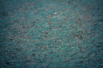 Extreme closeup of turquoise handmade paper with shallow depth of field.