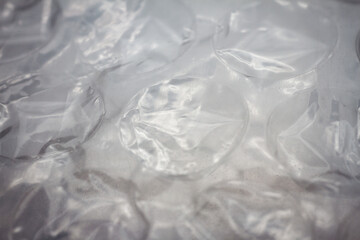 Extreme macro of plastic bubble wrap texture. Selective soft focus, shallow depth of field. Abstract dreamy background