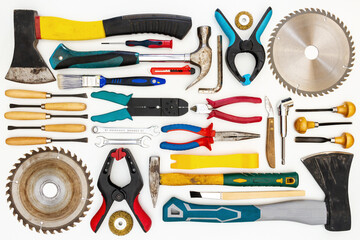 Flat lay of new and used hand tools on white background. Large collection of various tools and bits arranged on white.