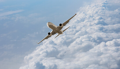 White passenger airplane flying in the sky amazing clouds in the background - Travel by air transport