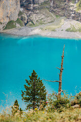 Crystal-Blue Oeschinensee Amid Snow-Capped Alpine Giants, Majestic Turquoise Lake Nestled Among Towering Mountains