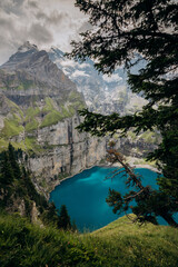 Crystal-Blue Oeschinensee Amid Snow-Capped Alpine Giants, Majestic Turquoise Lake Nestled Among Towering Mountains