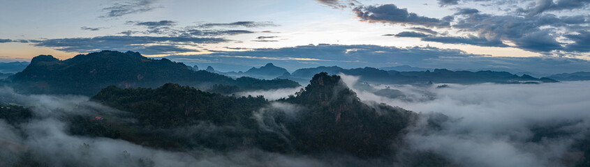 Aerial view A breathtaking view of dawn breaking over a misty mountain landscape, with layers of...