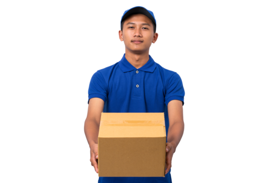 Smiling young asian delivery man wearing blue uniform holding cardboard box on white background