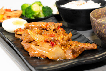 A well-balanced Asian-style set meal served on a tray, featuring tender braised beef strips (Hong Shao Niu Liu) as the main dish, accompanied by a bowl of steamed white rice, three assorted seasonal