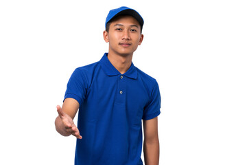Young asian delivery man wearing blue uniform smiling making a greeting gesture on white background