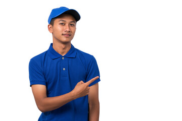 Smiling young asian delivery man wearing blue uniform pointing present a product