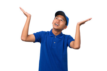 Smiling young asian delivery man wearing blue uniform pointing present a product