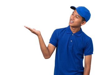 Smiling young asian delivery man wearing blue uniform pointing present a product