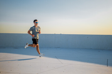 Running at sunset on a dreamlike rooftop in a cityscape setting