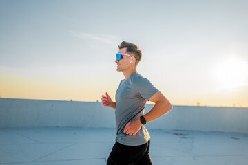Running at sunset on a rooftop, enjoying the last rays of a warm day
