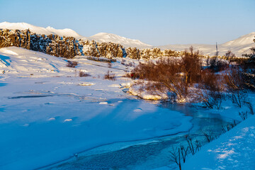 A beautiful winter afternoon in Thingvellir national park in Iceland, with a beautiful setting sun...