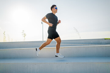 Runner ascends outdoor steps during a bright morning workout for fitness