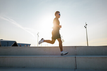 Runner enjoys a sunny evening jog on outdoor steps in perfect weather