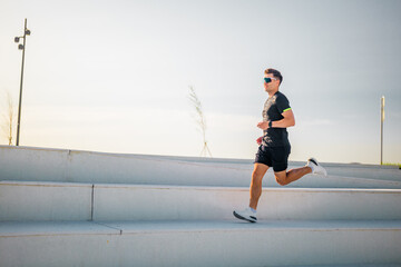 Runner enjoys a vibrant morning jog along scenic steps in a sunny park