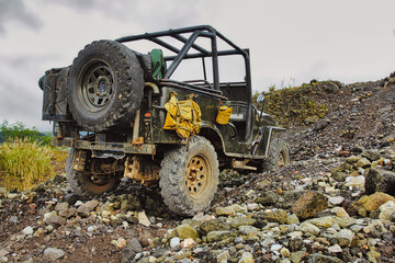 Jeep stuck on gravel during off-road adventure at Mount Merapi in Indonesia. © mgHasim 
