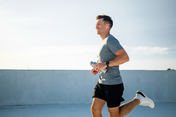 Fitness enthusiast enjoys a morning jog on a bright sunlit rooftop