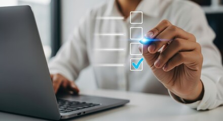 Photo of a persons hand with a glowing stylus checks off an item on a digital checklist, signifying task completion and successful goal achievement