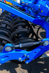 Fototapeta premium Agricultural machinery and parts of mechanisms on a sunny day. Texture, background for design. 