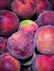 juicy peaches lying close together
