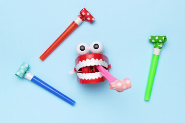 Colorful Toy Chattering Teeth with Whistles on Blue Background for Playful Fun Concept