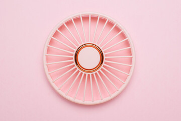 Minimalist Pink and White Circular Patterned Object on Pastel Background
