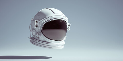 Fototapeta premium White astronaut helmet floats against single color background, creating futuristic and serene atmosphere. helmet reflective visor adds sense of mystery and exploration