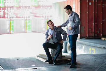 Warehouse staff relaxing after checking delivery schedules. Authentic break scene in supply chain...