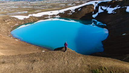 Majestic Krafla crater presents a stunning view with its deep blue waters set against dramatic...