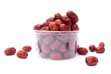 Red jujubes isolated on white background. Dried jujubes, also known as red dates, are a good source of fiber, which aids digestion and can help with weight management.