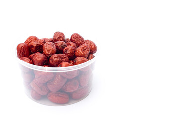 Red jujubes isolated on white background. Dried jujubes, also known as red dates, are a good source of fiber, which aids digestion and can help with weight management.