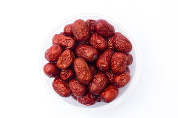 Red jujubes isolated on white background. Dried jujubes, also known as red dates, are a good source of fiber, which aids digestion and can help with weight management.