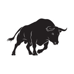 Powerful black silhouette of an angry bull charging forward with horns ready