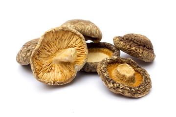 Dried shiitake mushrooms isolated on white background. They are a good source of vitamins, minerals, and antioxidants, and can potentially support immune function, heart health, and bone health.