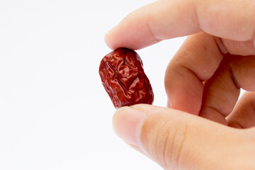 Red jujubes isolated on white background. Dried jujubes, also known as red dates, are a good source of fiber, which aids digestion and can help with weight management.
