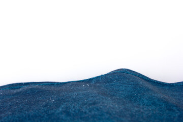 The blue fabric on the white background creates a background with a motif that has the shape of ocean waves.