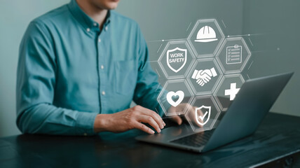 A person interacts with a digital interface displaying icons related to work safety, health, and business protection
